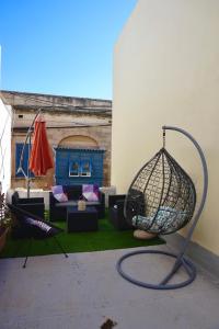 een terras met een vogelkooi in een tuin bij San Nikola Getaway in Sliema