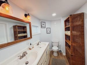 a bathroom with a sink and a toilet at Ultra Modern - Entire 3 Bedroom Apartment - 5 min walk to the Beach in Wildwood