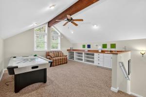 a living room with a ceiling fan and a desk at Mountain retreat w deck, game room & dog-friendly in Hedgesville