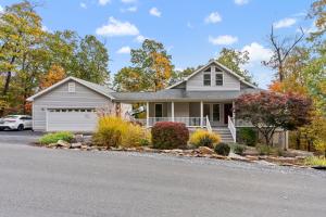 a house with a car parked in the driveway at Mountain retreat w deck, game room & dog-friendly in Hedgesville
