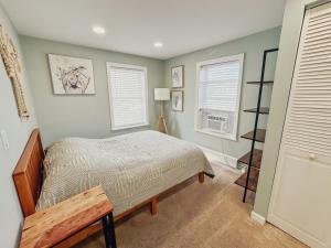 a bedroom with a bed and two windows at Ultra Modern - Entire 3 Bedroom Apartment - 5 min walk to the Beach in Wildwood