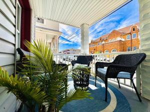 a porch with chairs and plants on a balcony at Ultra Modern - Entire 3 Bedroom Apartment - 5 min walk to the Beach in Wildwood