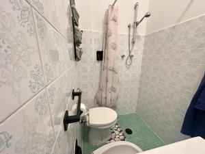 a small bathroom with a toilet and a shower at Tra Cielo e Mare da Vale in Fano +17 photos