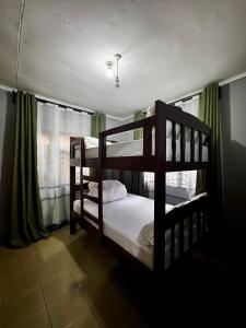 Giường trong phòng chung tại Givine Signature - Nyumbani Luxe