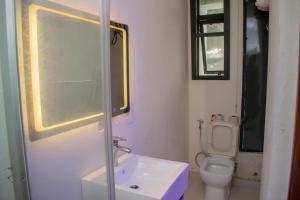 a bathroom with a sink and a toilet at PWJ Apartments in Lagos