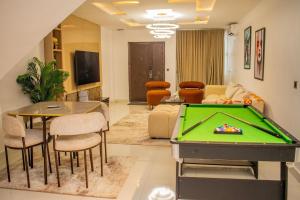 a living room with a pool table at PWJ Apartments in Lagos