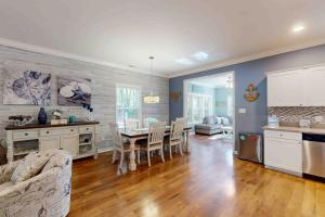 a kitchen and dining room with a table and chairs at 28 White Horse Dr, Ocean Pines, MD 21811 in Ocean Pines +8 photos