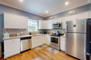 a kitchen with white cabinets and a stainless steel refrigerator at 28 White Horse Dr, Ocean Pines, MD 21811 in Ocean Pines