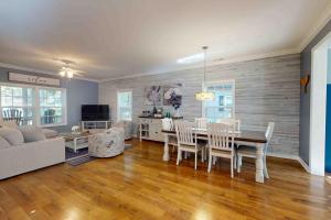 a dining room and living room with a table and chairs at 28 White Horse Dr, Ocean Pines, MD 21811 in Ocean Pines