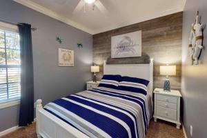 a bedroom with a bed with blue and white stripes at 28 White Horse Dr, Ocean Pines, MD 21811 in Ocean Pines