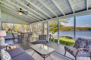 a screened in porch with a view of the water at half Mi to Song Mountain Resort Ski Getaway! in Tully