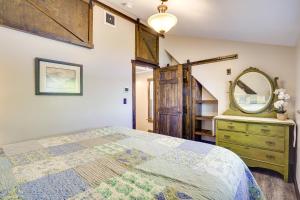 a bedroom with a bed and a mirror and a dresser at half Mi to Song Mountain Resort Ski Getaway! in Tully