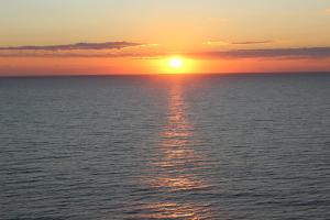 a sunset over the ocean with the sun setting at 19th Floor Oceanfront - Panoramic Views - Sleeps 10 - Caribbean Resort in Myrtle Beach
