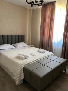 a bedroom with a bed with two towels on it at Lucky House in Grigoleti