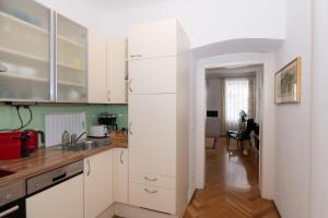 a kitchen with a white refrigerator in a room at Apartment Villa Penzing in Vienna
