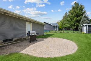 a barbecue grill sitting outside of a house at Cozy 3BR Retreat - Modern Finish & Great Location in Bettendorf