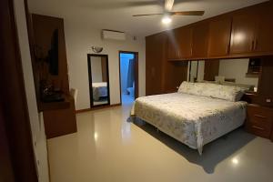 a bedroom with a bed and a dresser and a mirror at Casa El Tular - Alberca priv / a 5 min de la playa in Colonia Miramar +29 photos