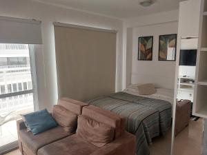 a living room with a couch and a bed at Conforto no Alto da Boa Vista in Sao Paulo +53 photos