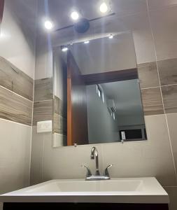 a bathroom with a sink and a mirror at Casa Madre Perla - a 2 min de la Playa Miramar in Colonia Miramar