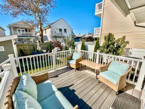 a patio with two chairs and a couch on a deck at Unique Wildwood 3 BR 1,5 BA Entire House in the Heart of Wildwood! in Wildwood