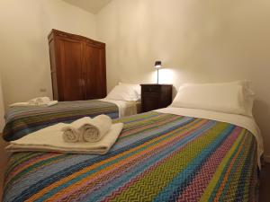 a bedroom with two beds with towels on them at A Casa di Luca in Faenza +26 photos