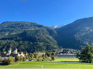 a town in a field with mountains in the background at Apartament La Terrazza in Stams