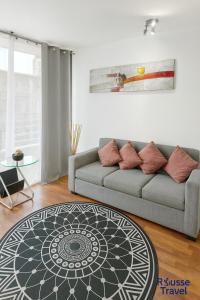 a living room with a couch and a table at Rousse 9 Santiago in Santiago