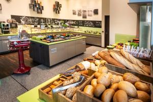 a bakery with lots of different types of bread at ACHAT Hotel Bremen City in Bremen