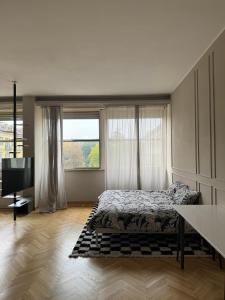 a bedroom with a bed and a large window at Casa26 - openspace in centro a Torino - in Turin