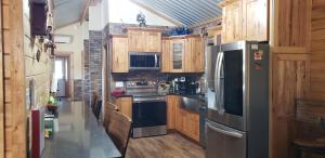 a kitchen with stainless steel appliances and wooden cabinets at Private Retreat with Pond, Pool and Hot Tub in Boyd