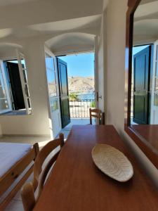 a dining room with a table with a plate on it at Archontiko Hotel in Kalymnos