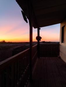 a view from the porch of a house at sunset at Pousada degamix in Barroquinha +8 photos