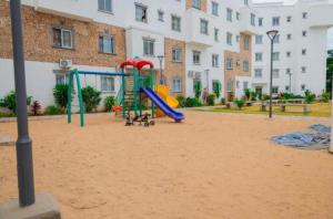 a playground with a slide in front of a building at Buxton Homes in Mombasa CBD in Mombasa