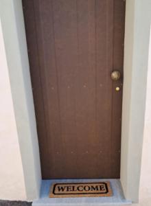 a welcoming door to a welcome sign in a hallway at FilAuri La Morra in La Morra