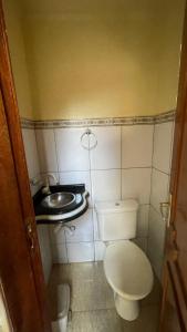 a small bathroom with a toilet and a sink at Apto 13 - Residencial Canaã in Porto Velho
