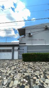 a building with two garage doors and a stone driveway at Apto 13 - Residencial Canaã in Porto Velho +15 photos