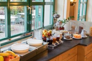 a kitchen counter with a bunch of food on it at Motel Baden in Baden