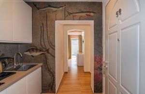 a kitchen with a fish mural on the wall at Tirreno Beachfront Apartments in Marina di Massa +29 photos
