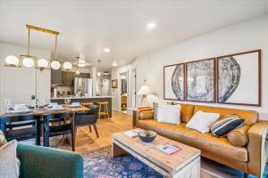 a living room with a couch and a table at Ski In/Ski Out Pico Resort Unit E106: 3BR newly renovated condo in Telemark Village +24 photos