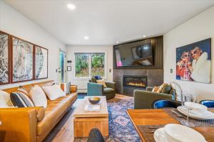 a living room with a couch and a fireplace at Ski In/Ski Out Pico Resort Unit E106: 3BR newly renovated condo in Telemark Village