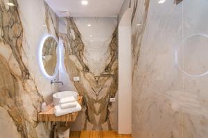 a bathroom with a wall mural of aopus at Tirreno Beachfront Apartments in Marina di Massa