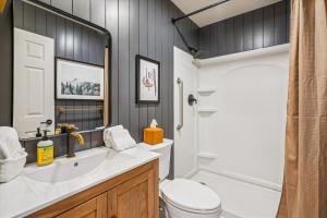 a bathroom with a sink and a toilet and a tub at Ski In/Ski Out Pico Resort Unit E106: 3BR newly renovated condo in Telemark Village