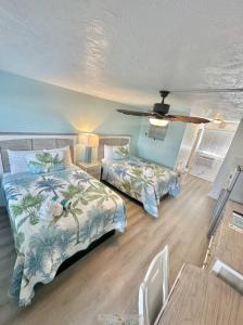 a bedroom with two beds and a ceiling at Malibu Resort Motel in St Pete Beach