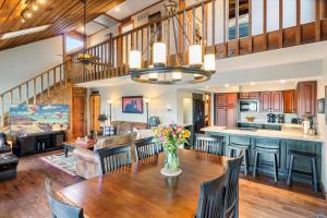 a kitchen and living room with a table and chairs at Cozy Digs Lake Lodge w/ 2 Decks, Game Room, Private Dock & Boat Slip in Osage Beach