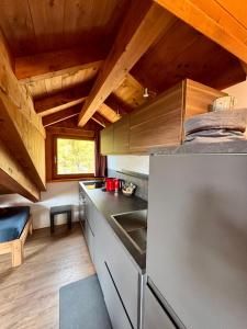 a kitchen with wooden ceilings and a counter top at Sky Lodge Bellamonte in Bellamonte