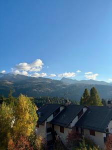 a row of houses with mountains in the background at Sky Lodge Bellamonte in Bellamonte