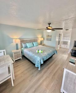a bedroom with a bed and a ceiling fan at Malibu Resort Motel in St Pete Beach