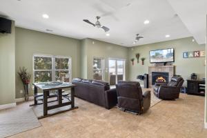 een woonkamer met lederen meubels en een open haard bij Sunrise, Wildlife & Paddle Boarding Awaits! in Sunrise Beach