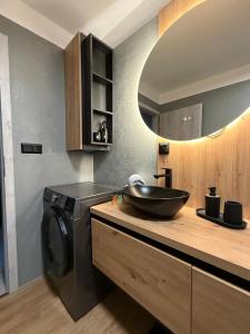 a bathroom with a sink and a washing machine at Apartmán Lottner in Kysucké Nové Mesto