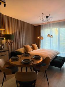 a bedroom with a bed and a table with chairs at Apartmán Lottner in Kysucké Nové Mesto